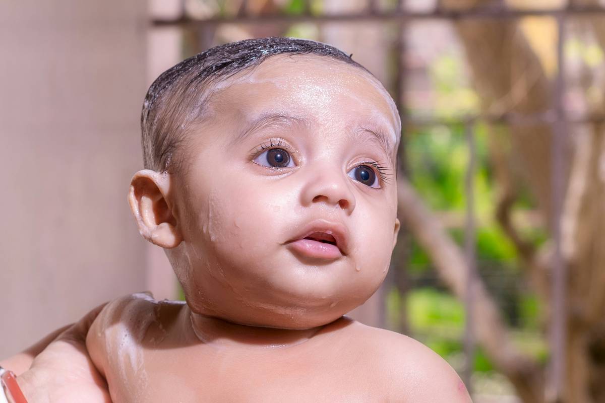 Gentle face wipes for kids being used on a toddler's clean cheek
